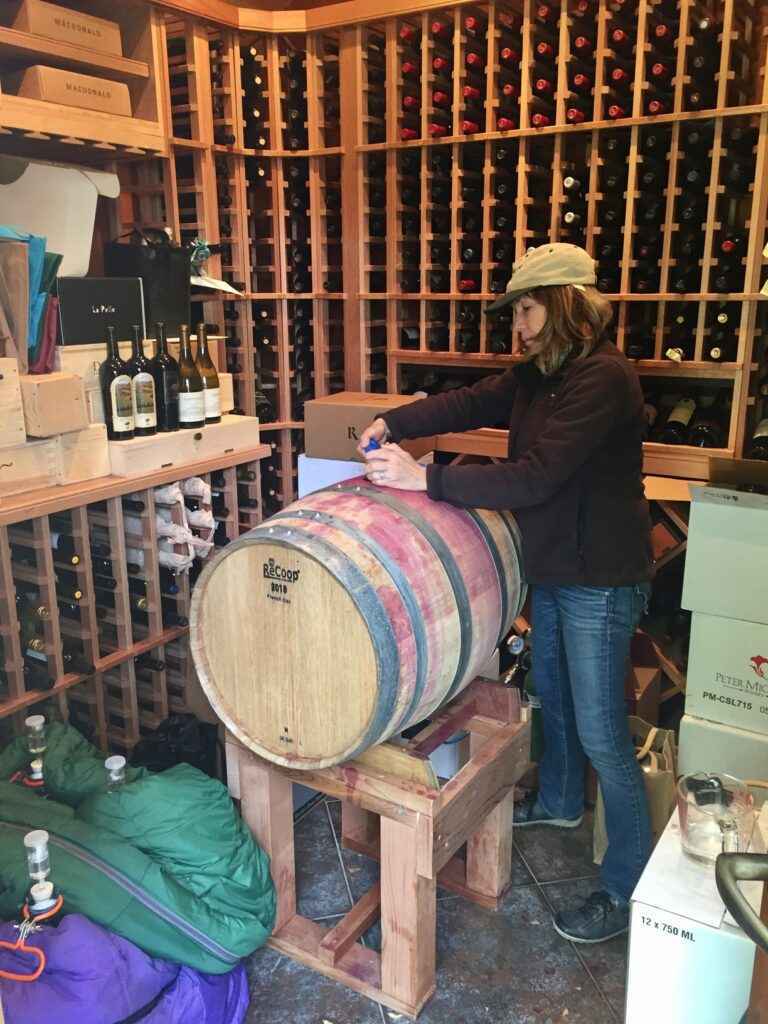 Felicia practicing the art of wineaking n her wine cellar
