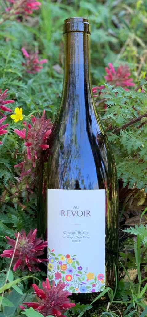 Au Revoir Chenin Blanc Bottle atop Wildflowers